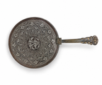 Islamic copper hand mirror front view showing silver-inlaid girih arabesque pattern