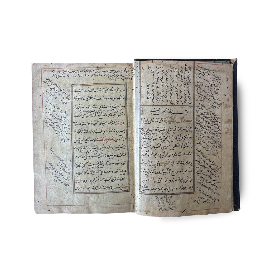 Ottoman Arabic manuscript — open spread showing text with rubrication and marginal notes