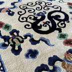 Close-up detail of dragon and cloud motifs on Tianjin silk carpet