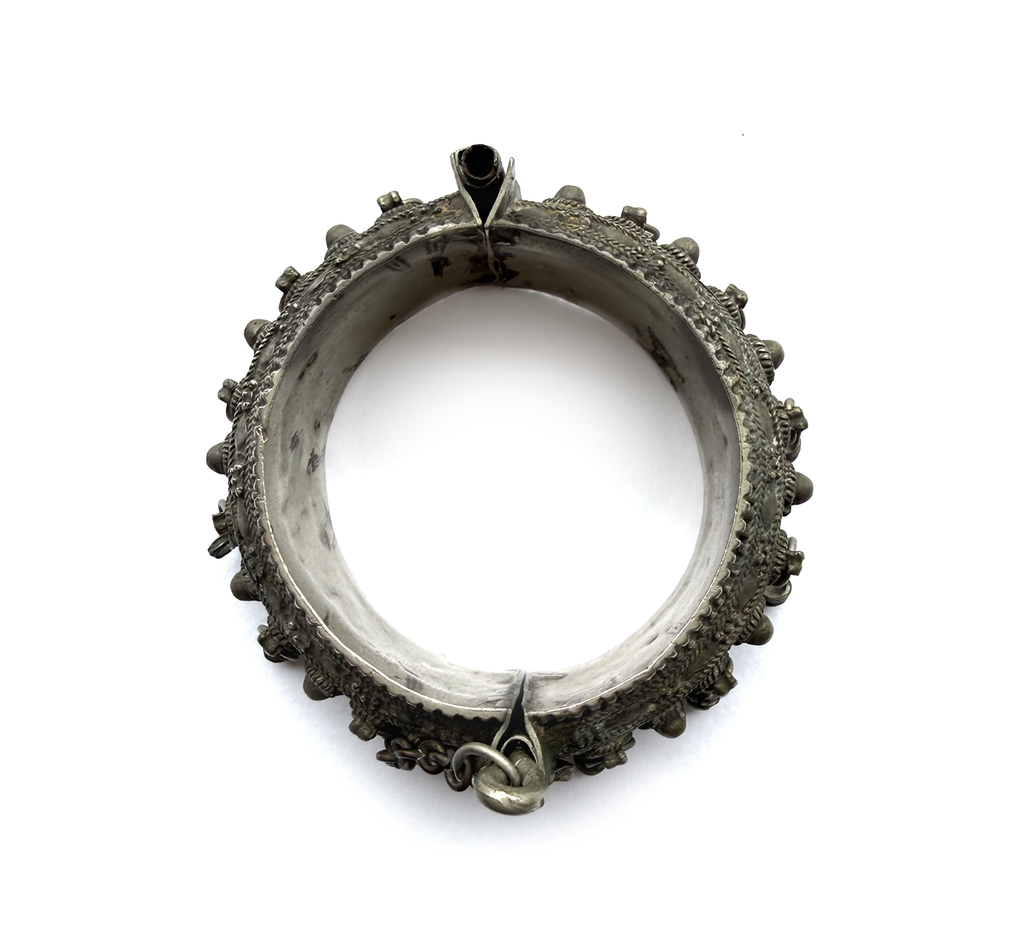 Antique Arabian silver hinged bangle, top view showing full form