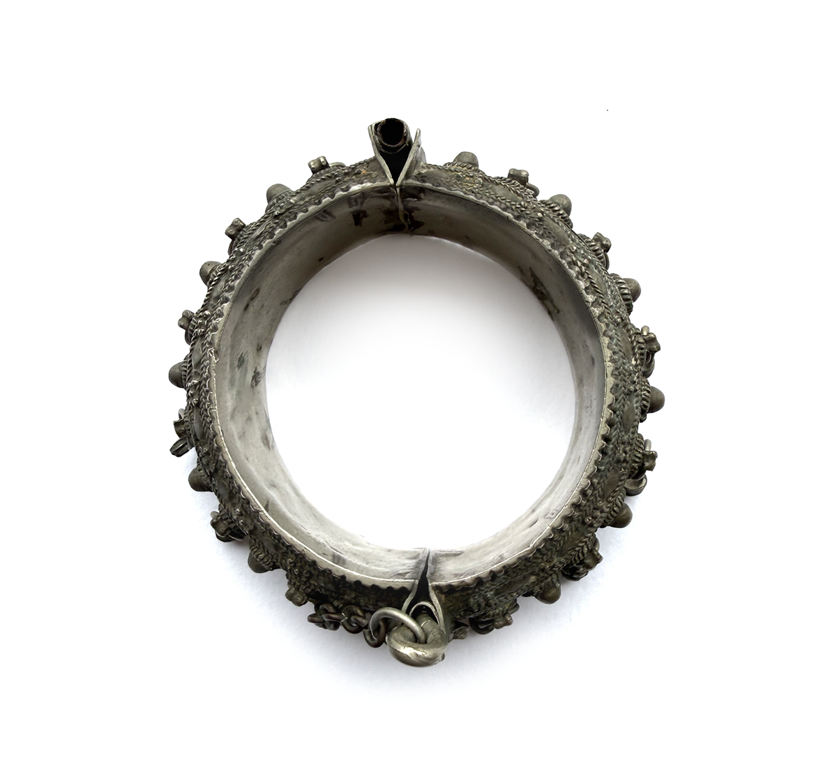 Antique Arabian silver hinged bangle, top view showing full form